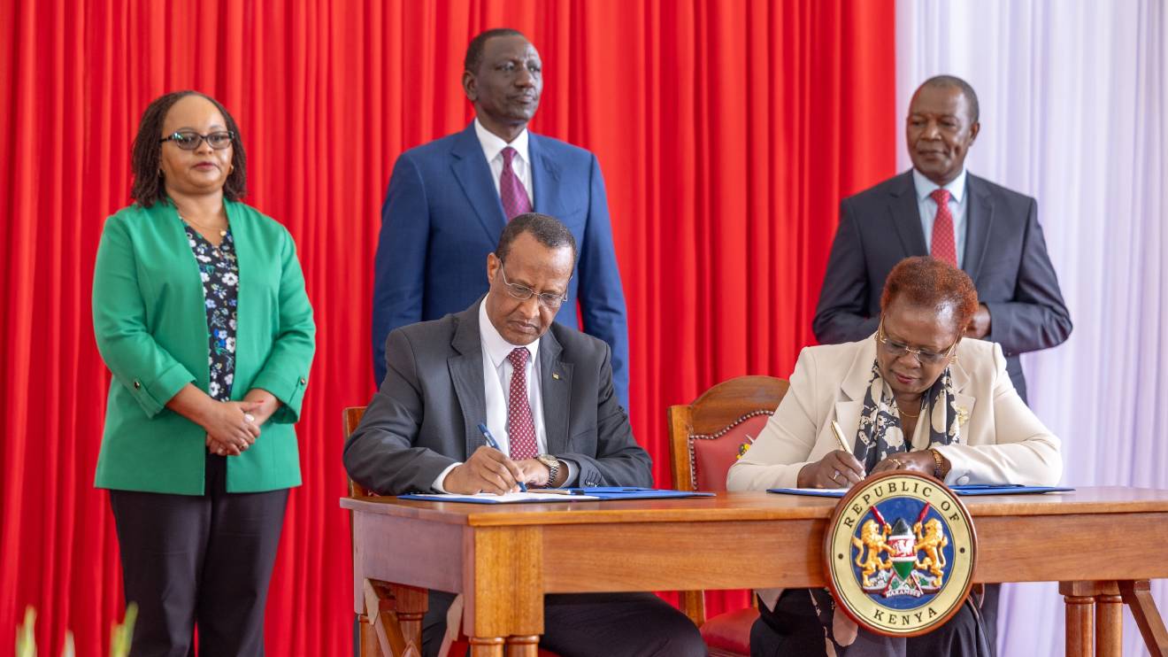 Anne Waiguru, William Ruto and Njuguna Ndung'u witness the signing of a document during the launch of the second Kenya Urban Support Program (KUSP II) at State House. PHOTO/COURTESY